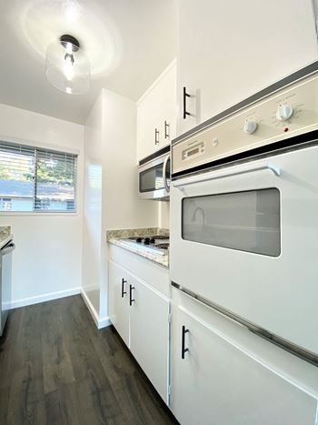 Kitchen with oven and hardwood floors